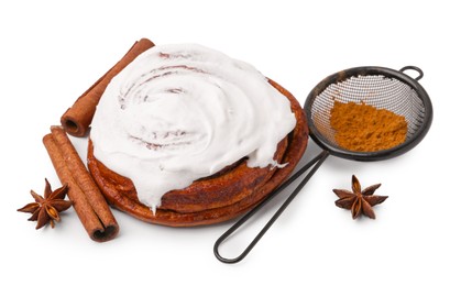 Photo of Tasty cinnamon roll with cream and spices isolated on white