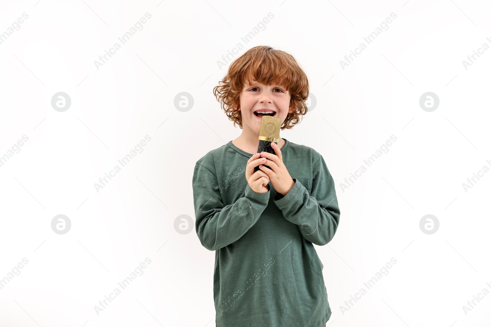 Photo of Little boy with microphone singing on white background