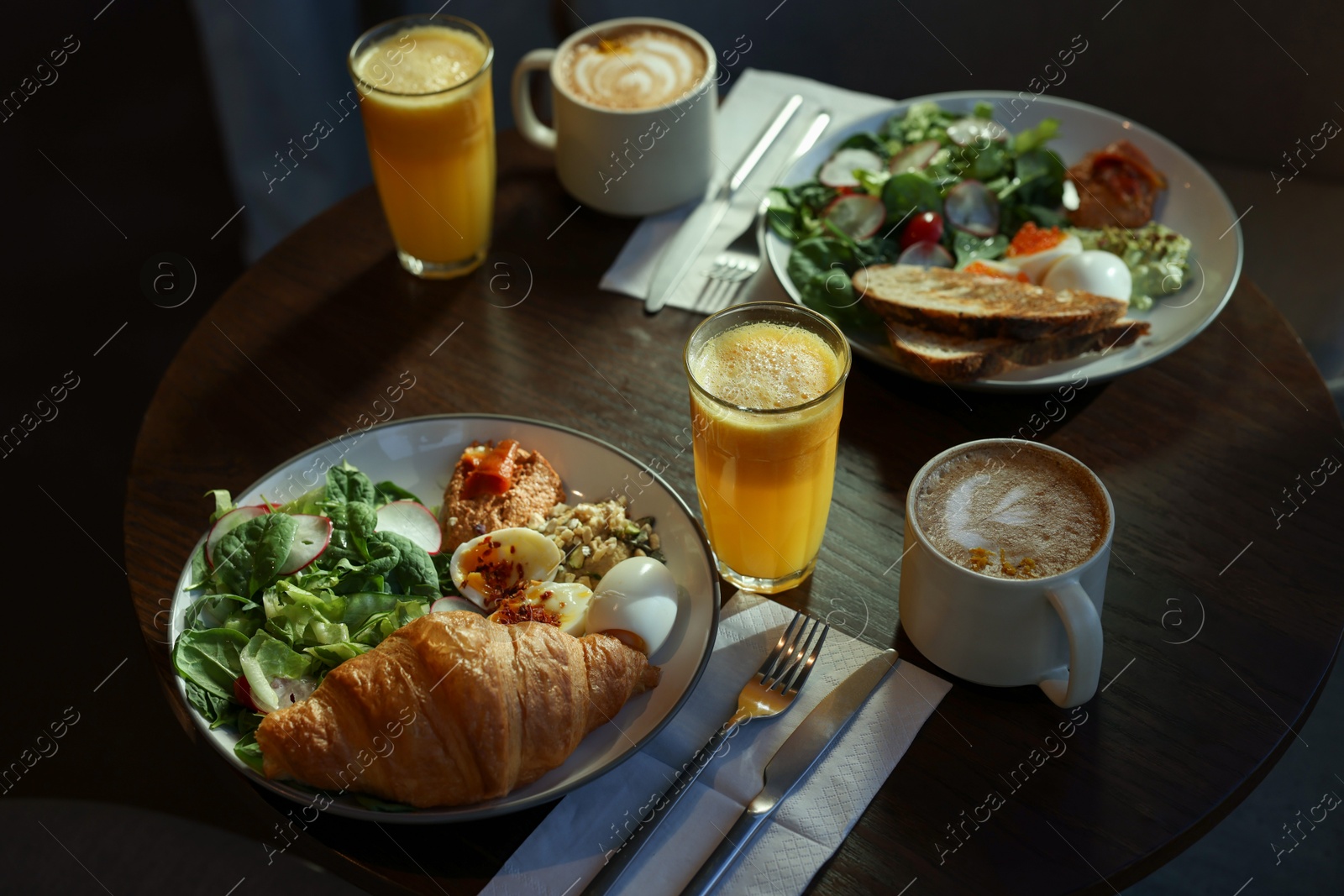 Photo of Tasty breakfast. Different meals and drinks served on wooden table in cafe, closeup