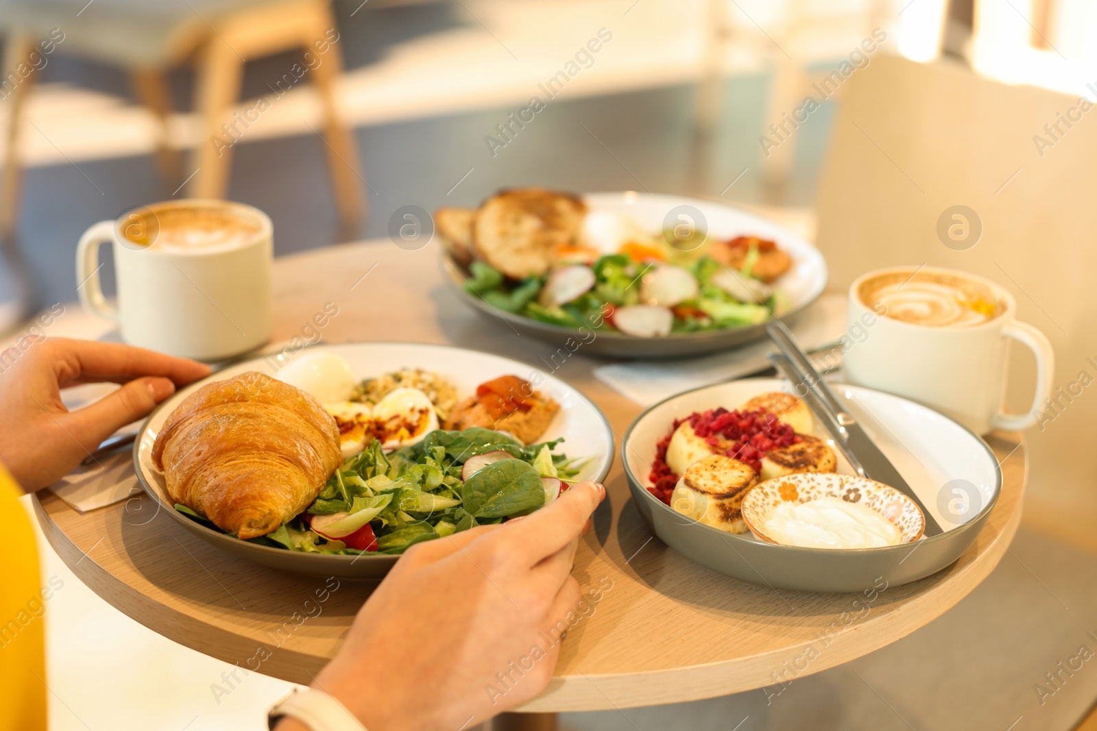 Photo of Woman having tasty breakfast in cafe, closeup