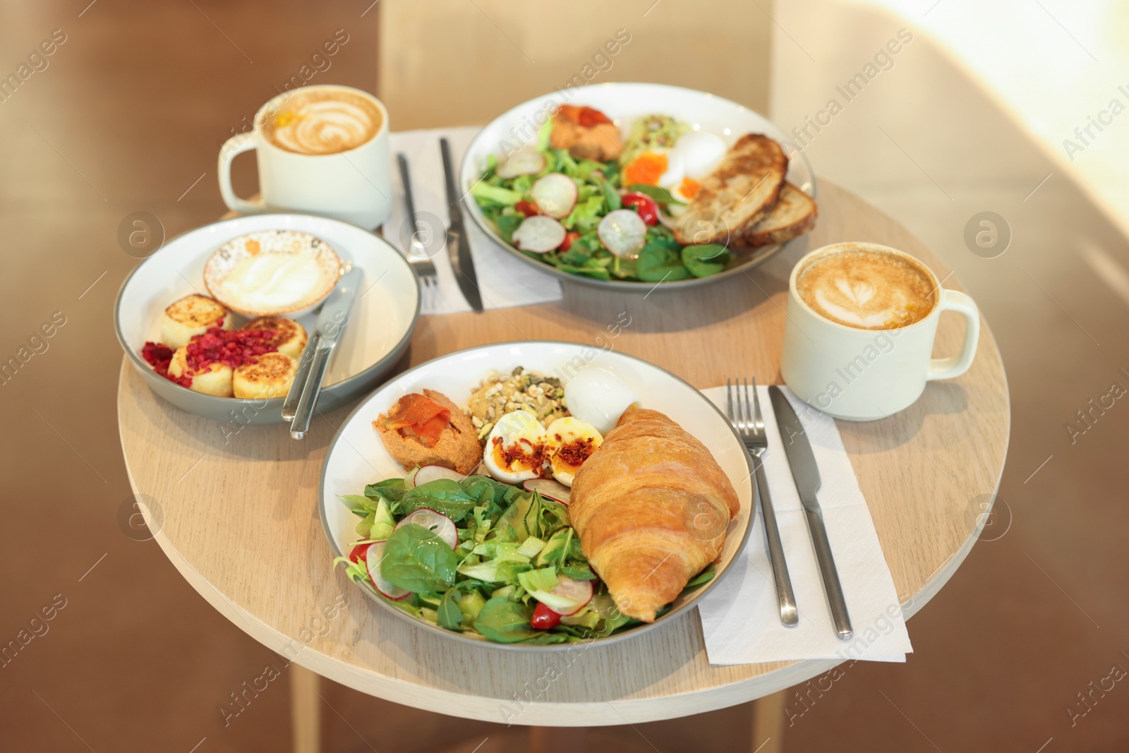 Photo of Tasty breakfast. Different meals and coffee served on wooden table in cafe