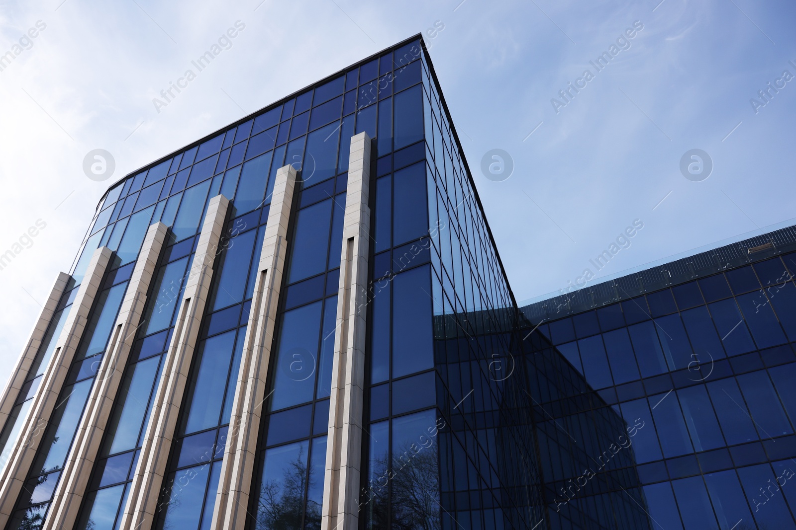 Photo of Exterior of modern building with many windows outdoors, low angle view