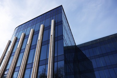 Photo of Exterior of modern building with many windows outdoors, low angle view