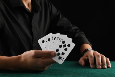 Photo of Man with cards playing poker at gambling table, closeup