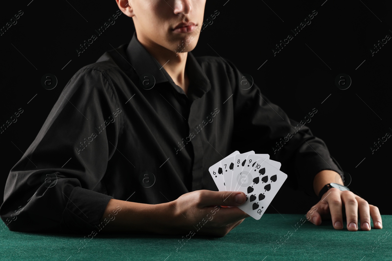 Photo of Man with cards playing poker at gambling table, closeup