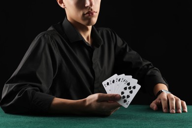 Photo of Man with cards playing poker at gambling table, closeup