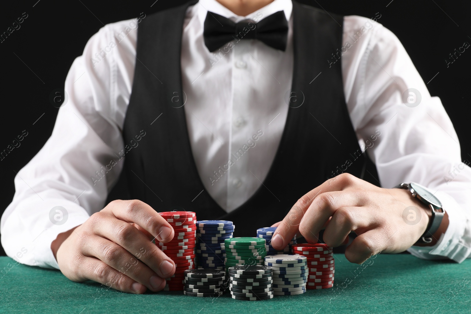 Photo of Man with casino chips playing poker at gambling table, closeup