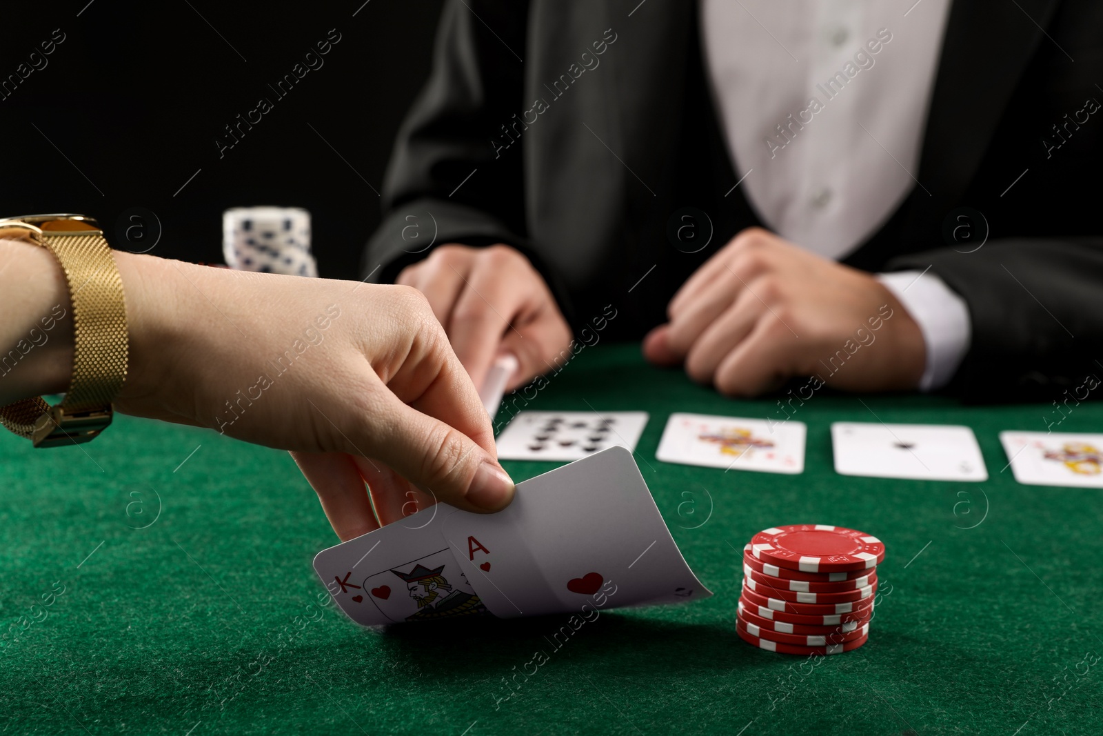 Photo of People playing poker with cards and casino chips at gambling table, closeup