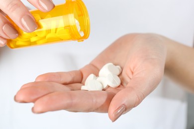 Photo of Woman with bottle of antibiotic pills, closeup