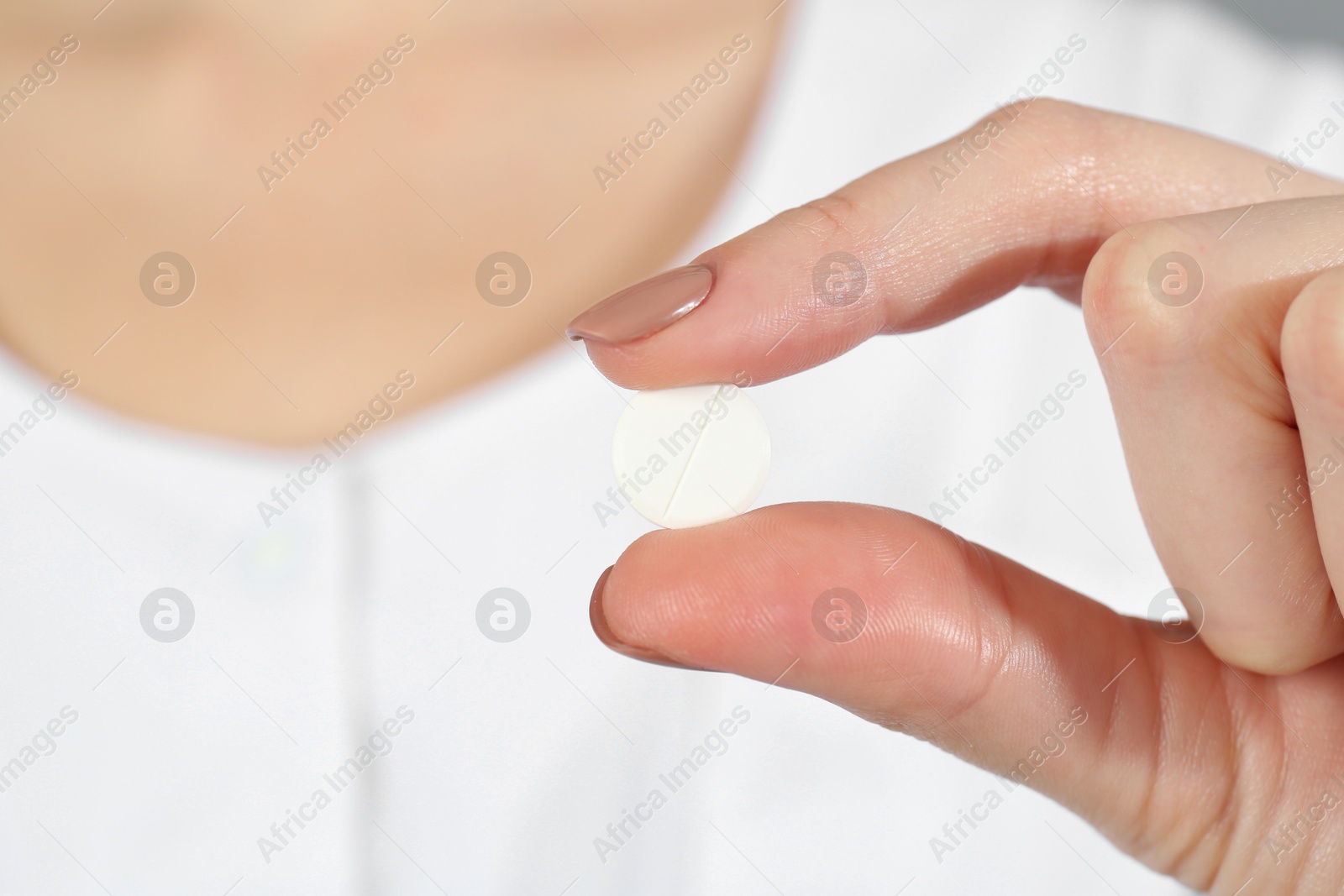 Photo of Woman holding antibiotic pill, closeup. Selective focus