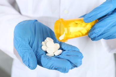 Photo of Doctor with bottle of antibiotic pills, closeup