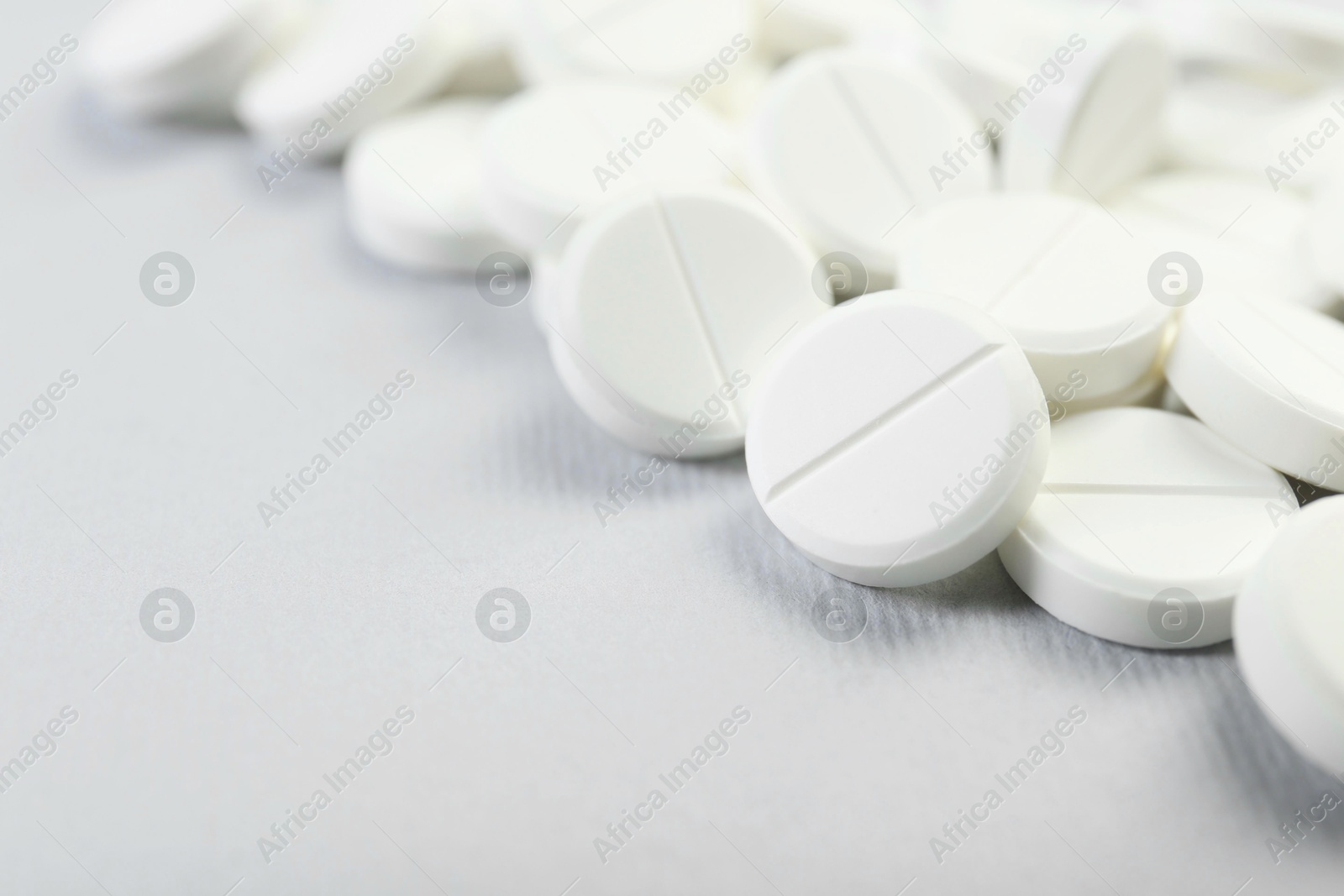 Photo of Many antibiotic pills on grey background, closeup. Space for text