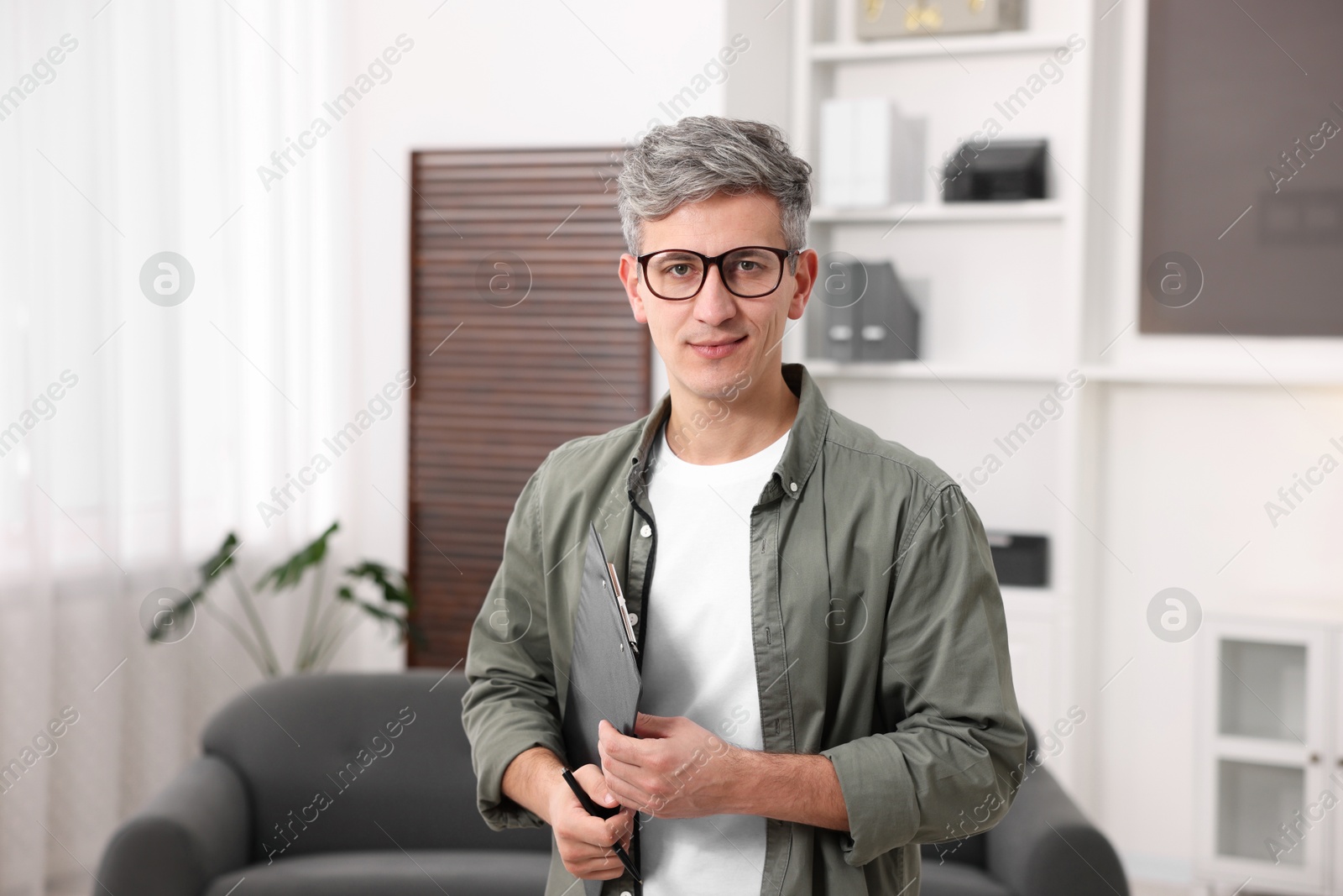 Photo of Portrait of professional psychologist with clipboard in office