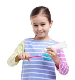 Photo of Cute girl applying toothpaste onto toothbrush on white background