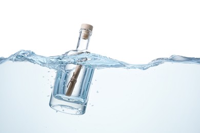 Photo of Corked glass bottle with rolled letter in water on white background