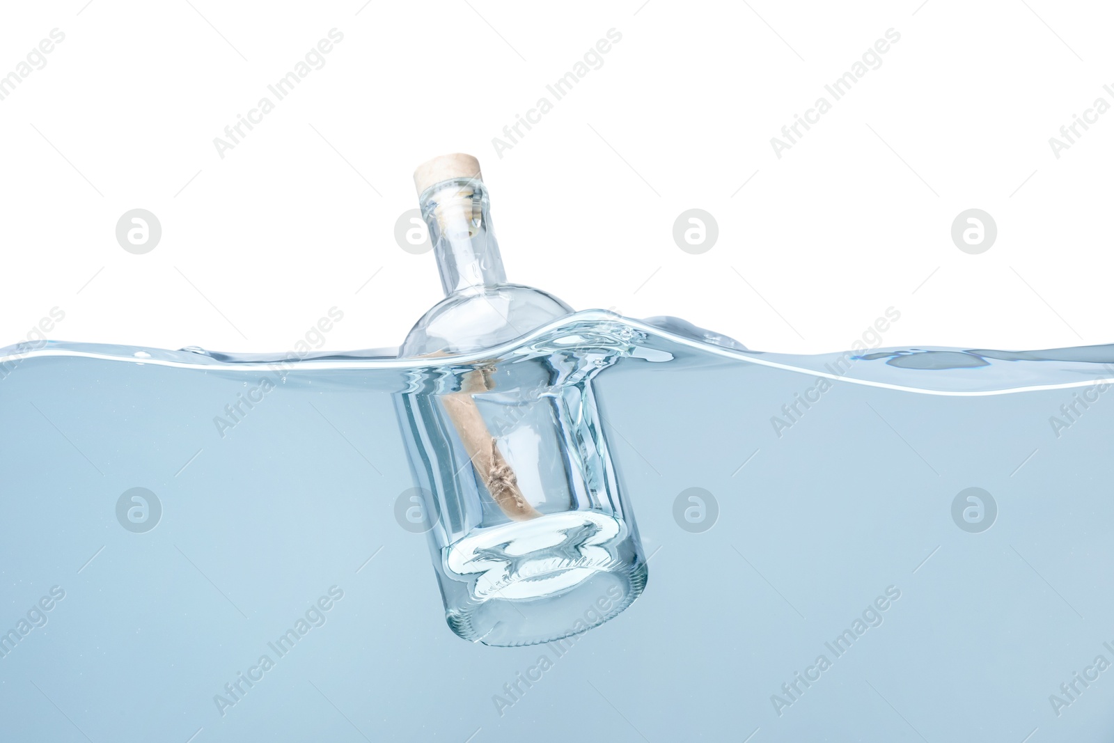 Photo of Corked glass bottle with rolled letter in water on white background