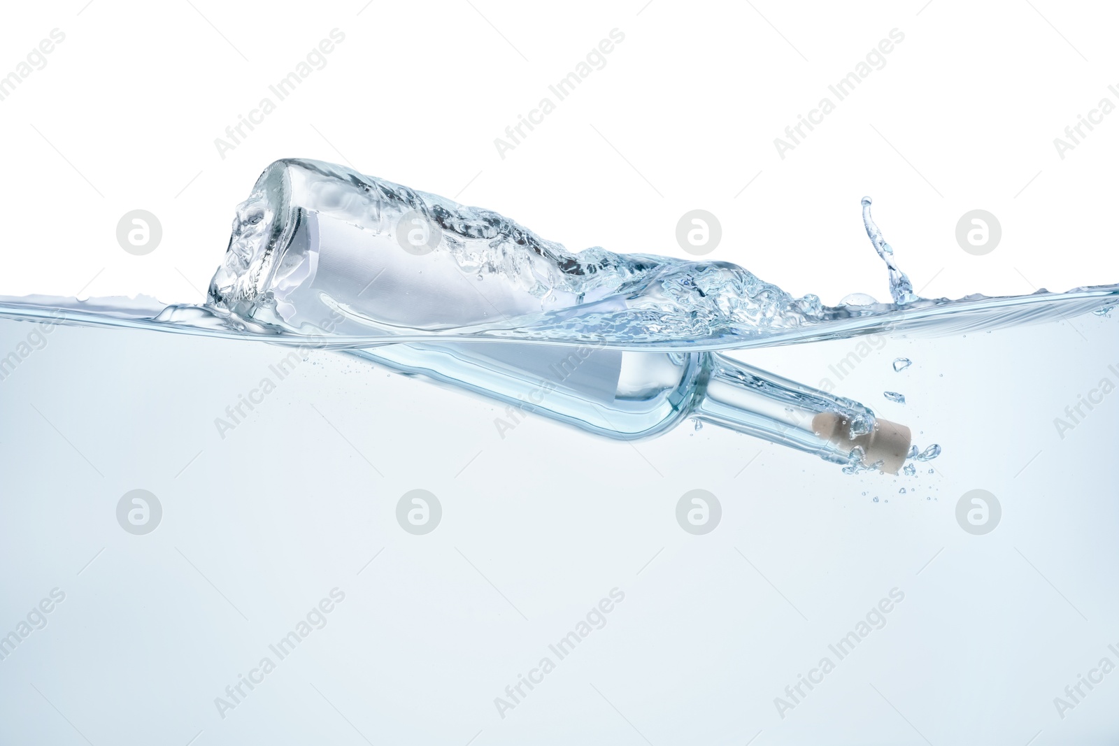 Photo of Corked glass bottle with rolled letter in water on white background