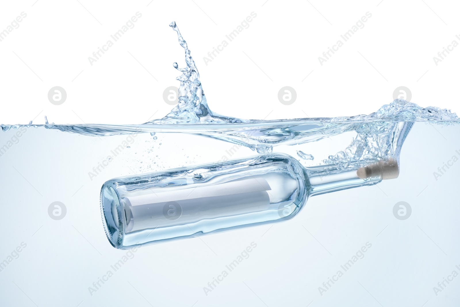 Photo of Corked glass bottle with rolled letter in water on white background