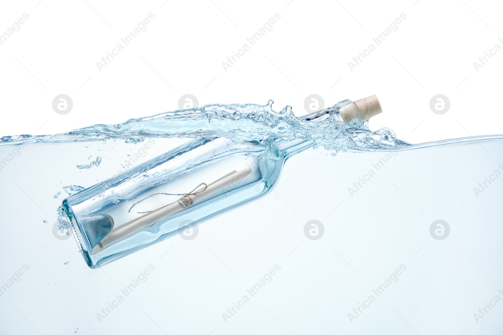 Photo of Corked glass bottle with rolled letter in water on white background