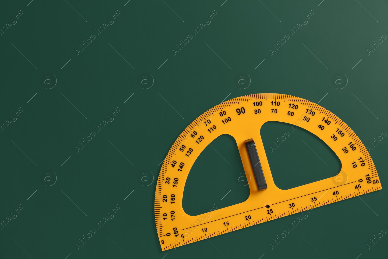 Photo of Protractor ruler on green chalkboard, top view. Space for text