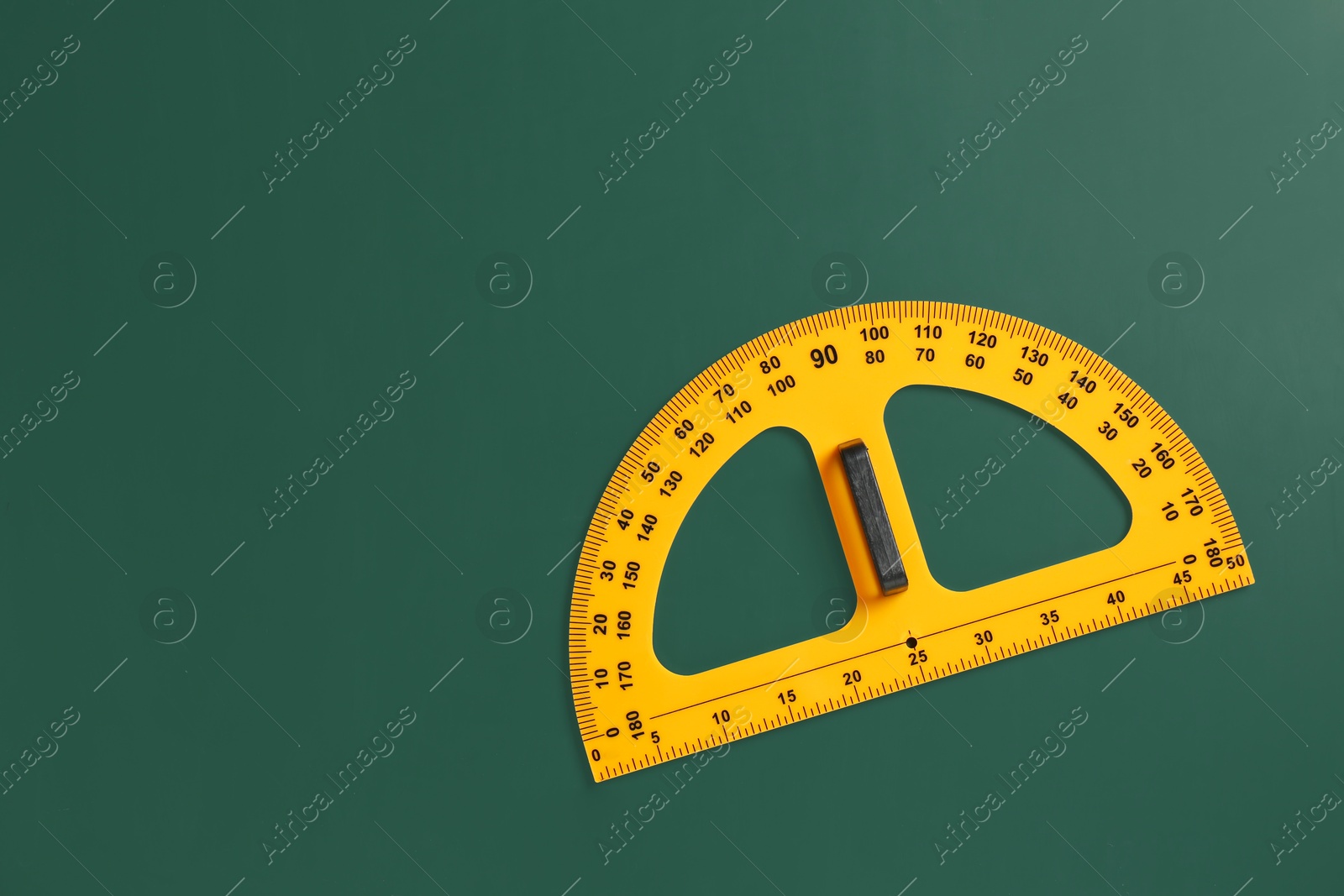 Photo of Protractor ruler on green chalkboard, top view. Space for text