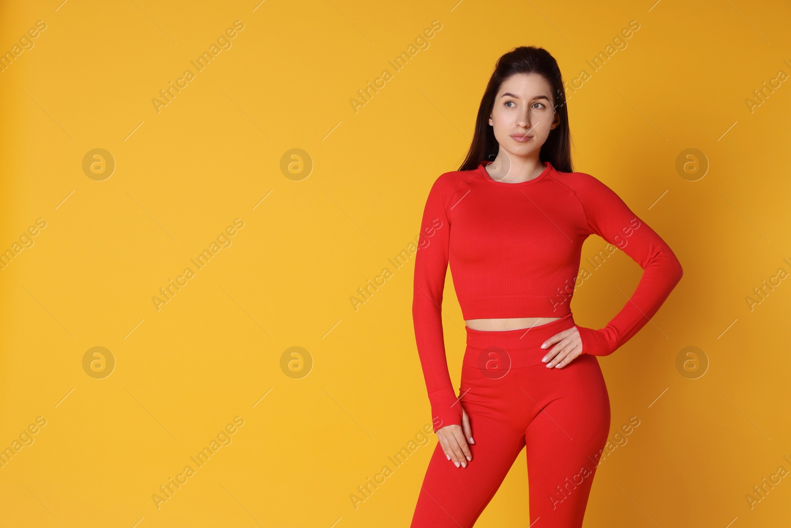 Photo of Portrait of woman in sportswear on orange background, space for text