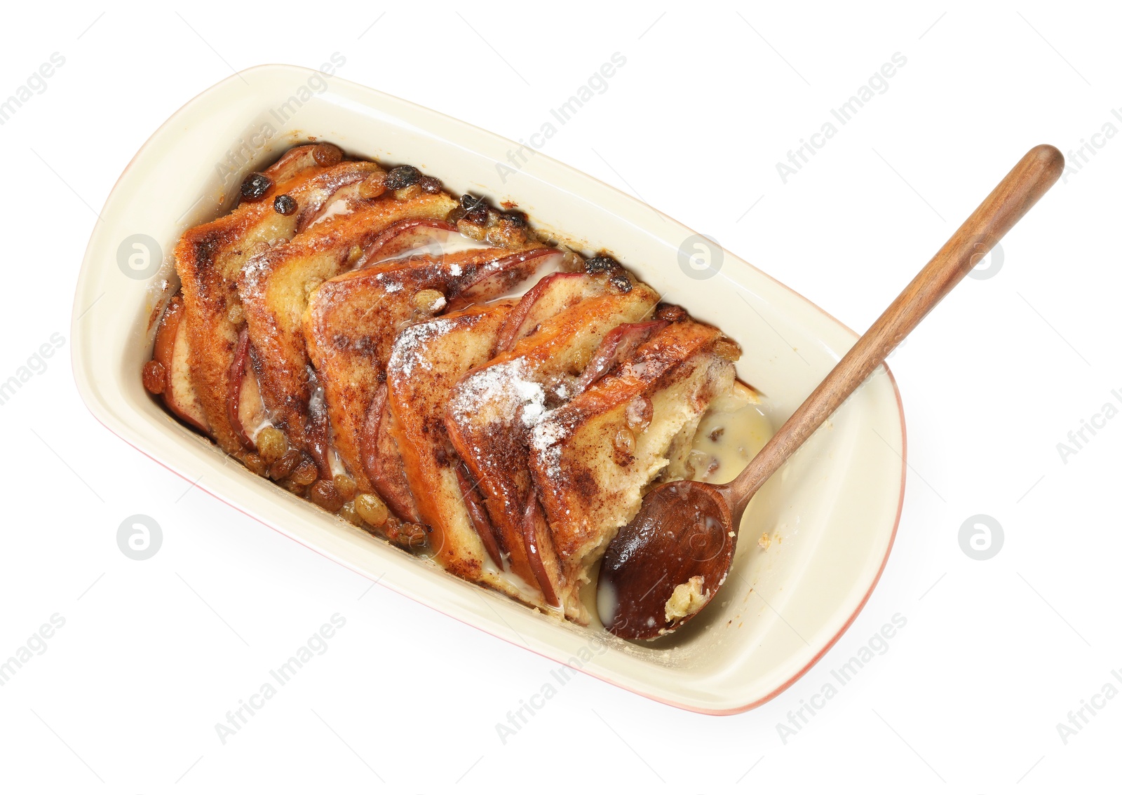 Photo of Freshly baked bread pudding in baking dish and spoon isolated on white, top view