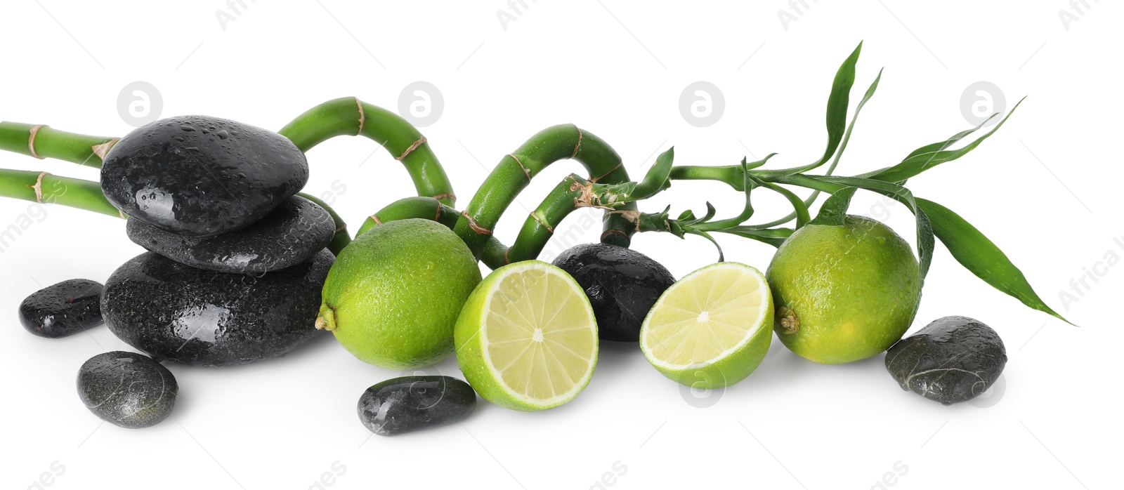 Spa composition with limes, massage stones and bamboo stems isolated on white Photo of Spa composition with limes, massage stones and bamboo stems isolated on white