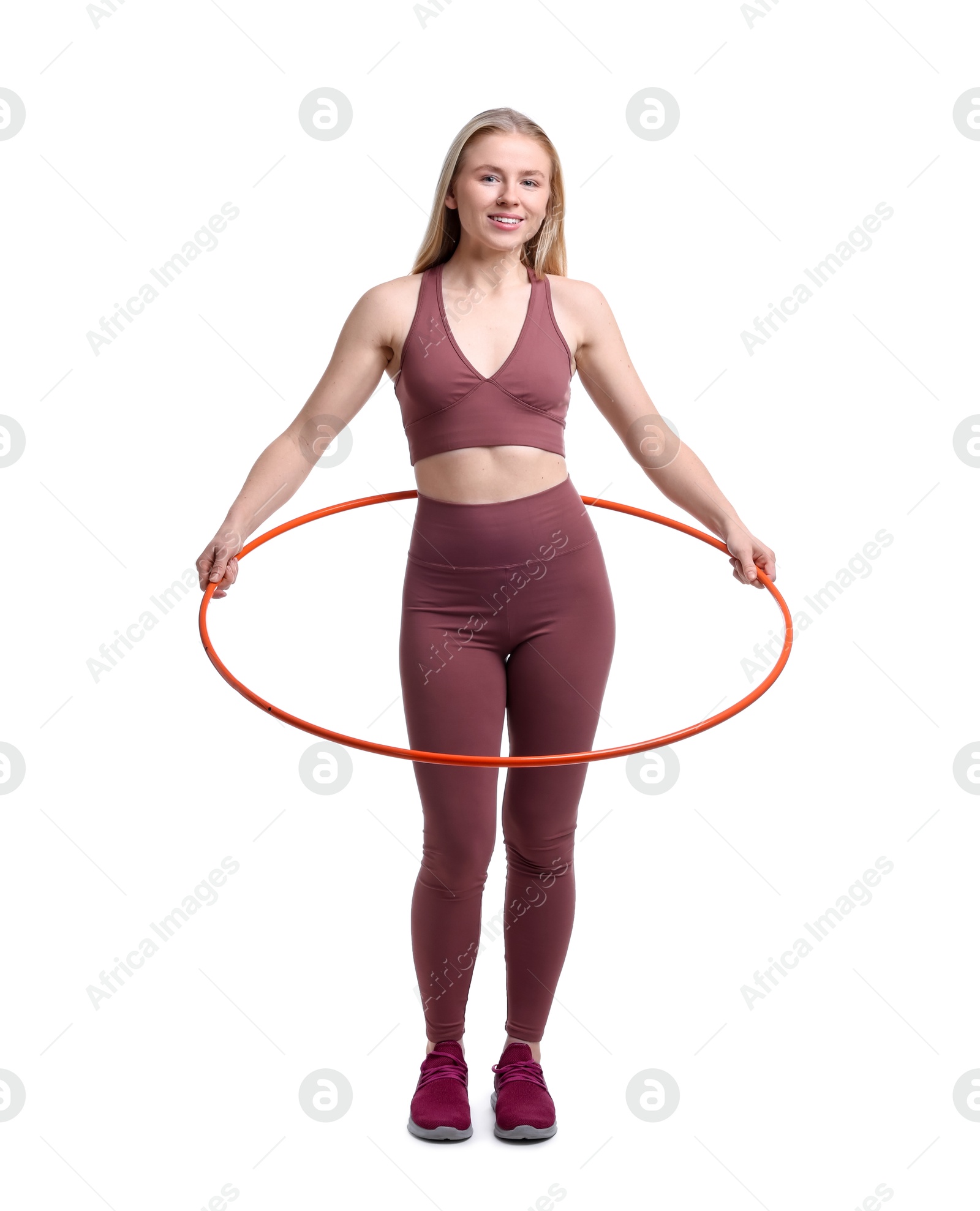 Photo of Beautiful young woman exercising with hula hoop on white background