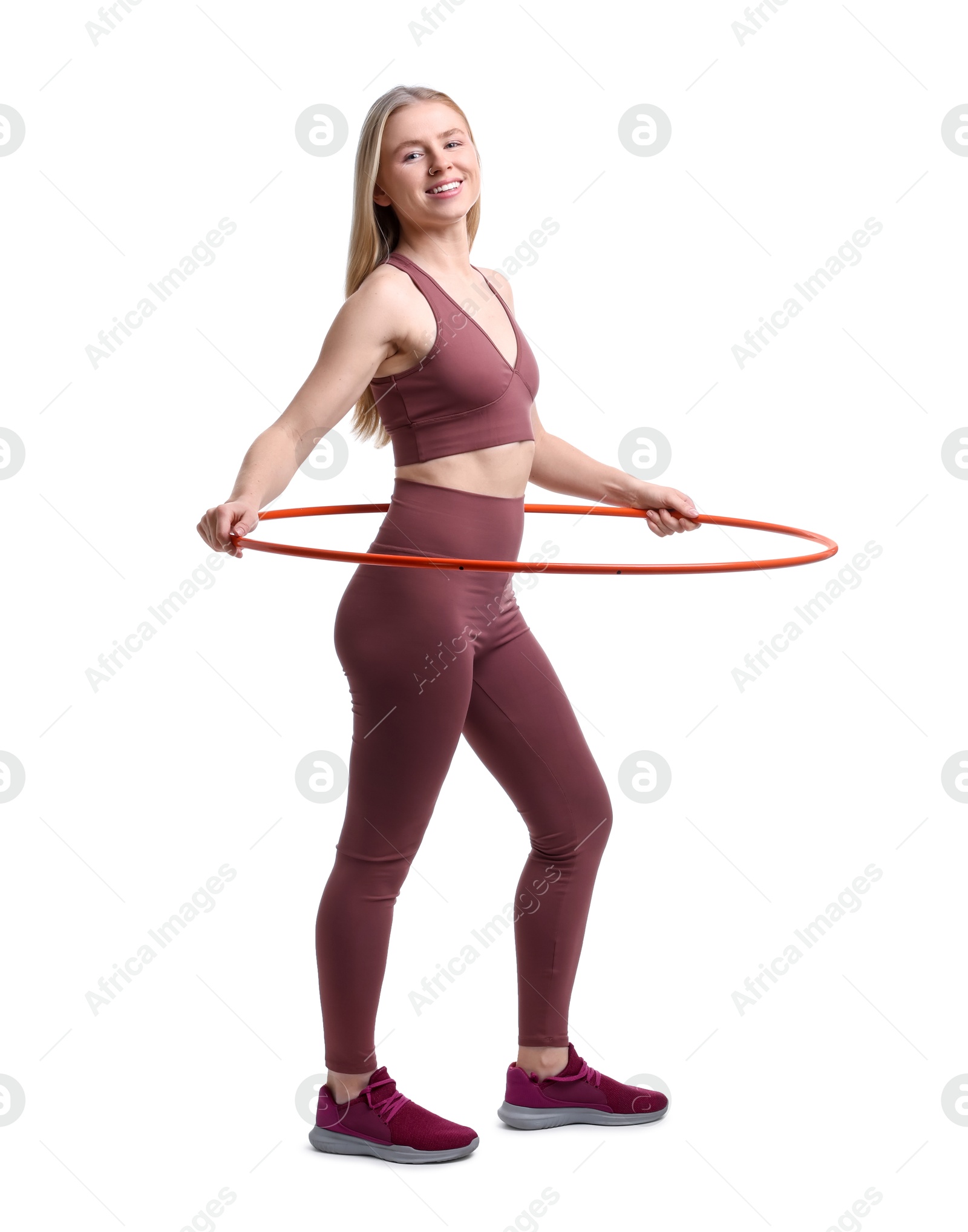 Photo of Beautiful young woman exercising with hula hoop on white background