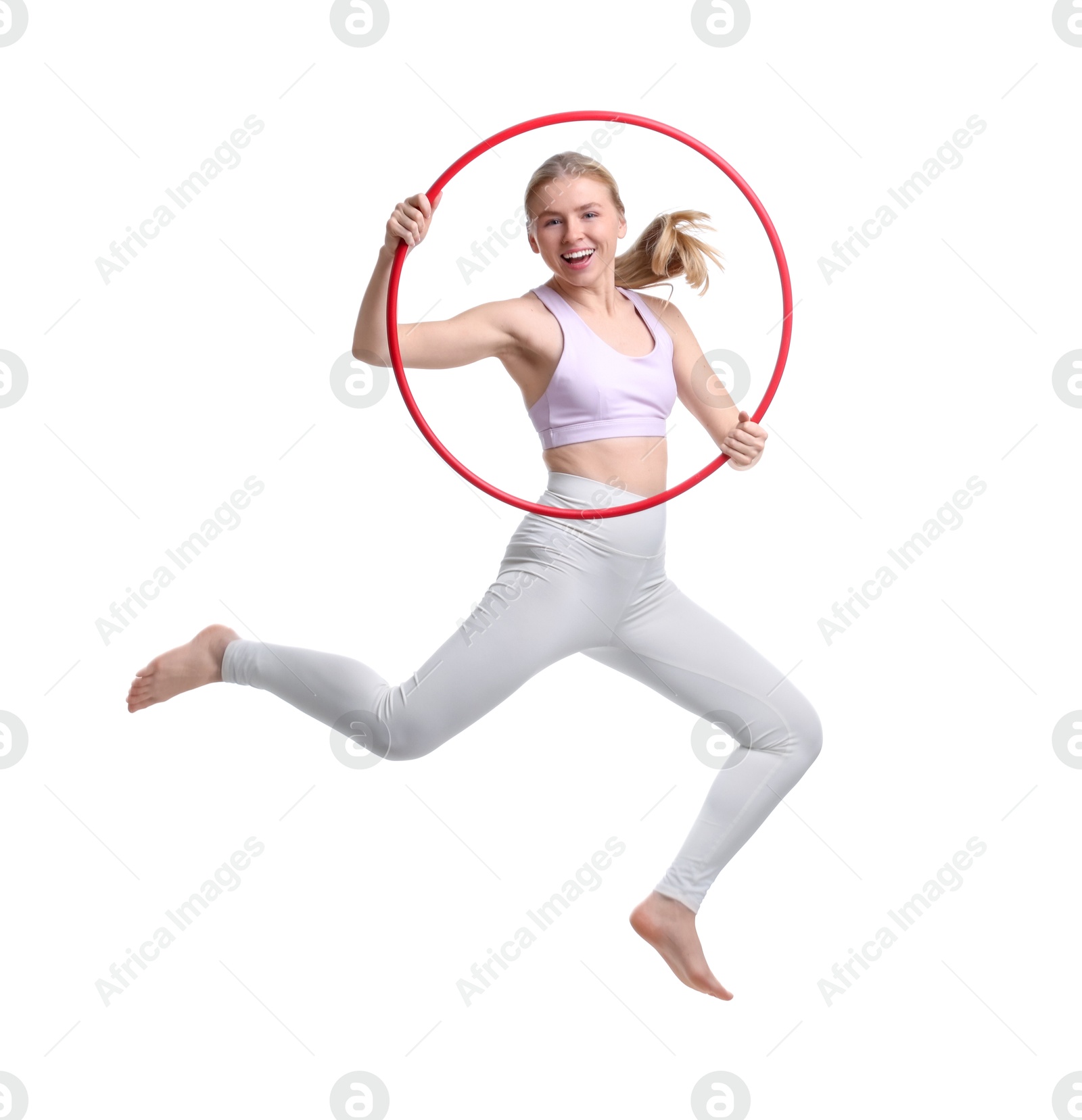 Photo of Beautiful young woman jumping with hula hoop on white background