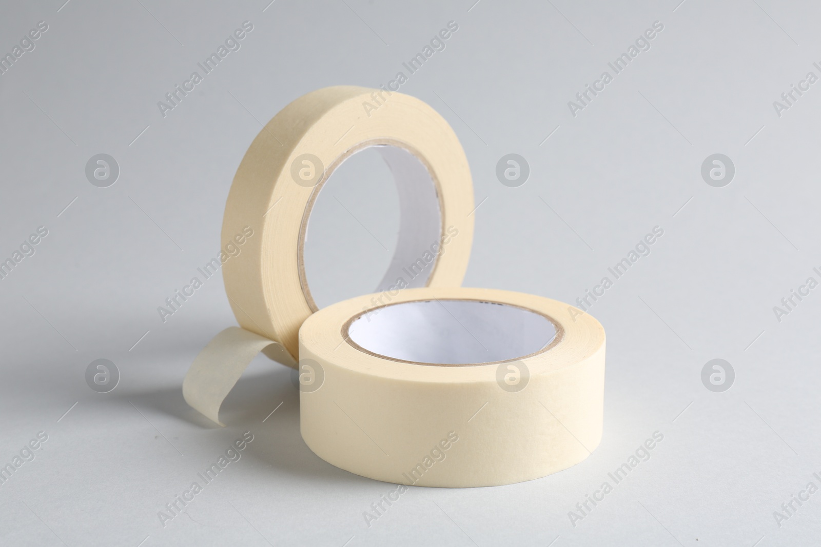 Photo of Two masking tapes on grey background, closeup