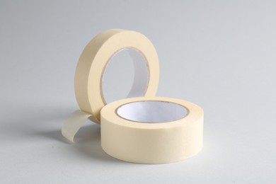 Photo of Two masking tapes on grey background, closeup