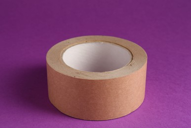 Roll of masking tape on violet background