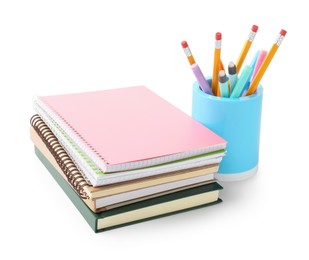 Photo of Stack of notebooks, books and other stationery on white background