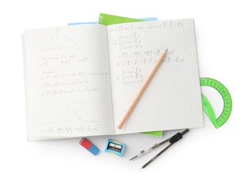 Photo of Doing homework. Notebook with math assignment and stationery on white background, top view