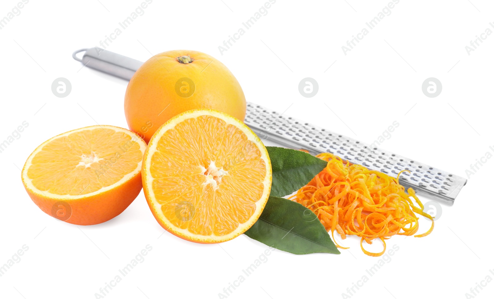 Photo of Pile of fresh orange zest, fruits, leaves and grater isolated on white