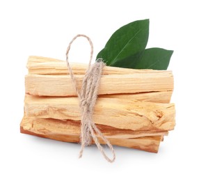 Photo of Bunch of palo santo sticks and green leaves on white background