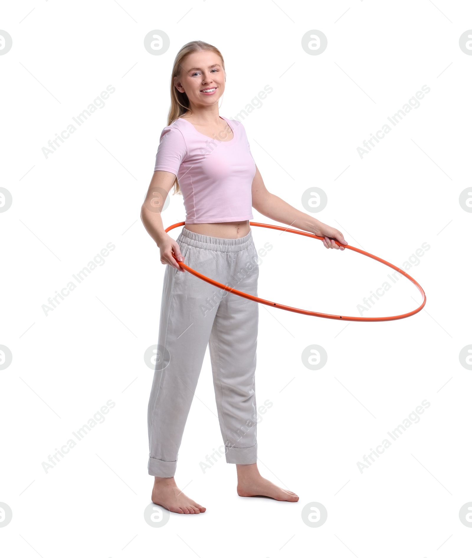 Photo of Beautiful young woman exercising with hula hoop on white background