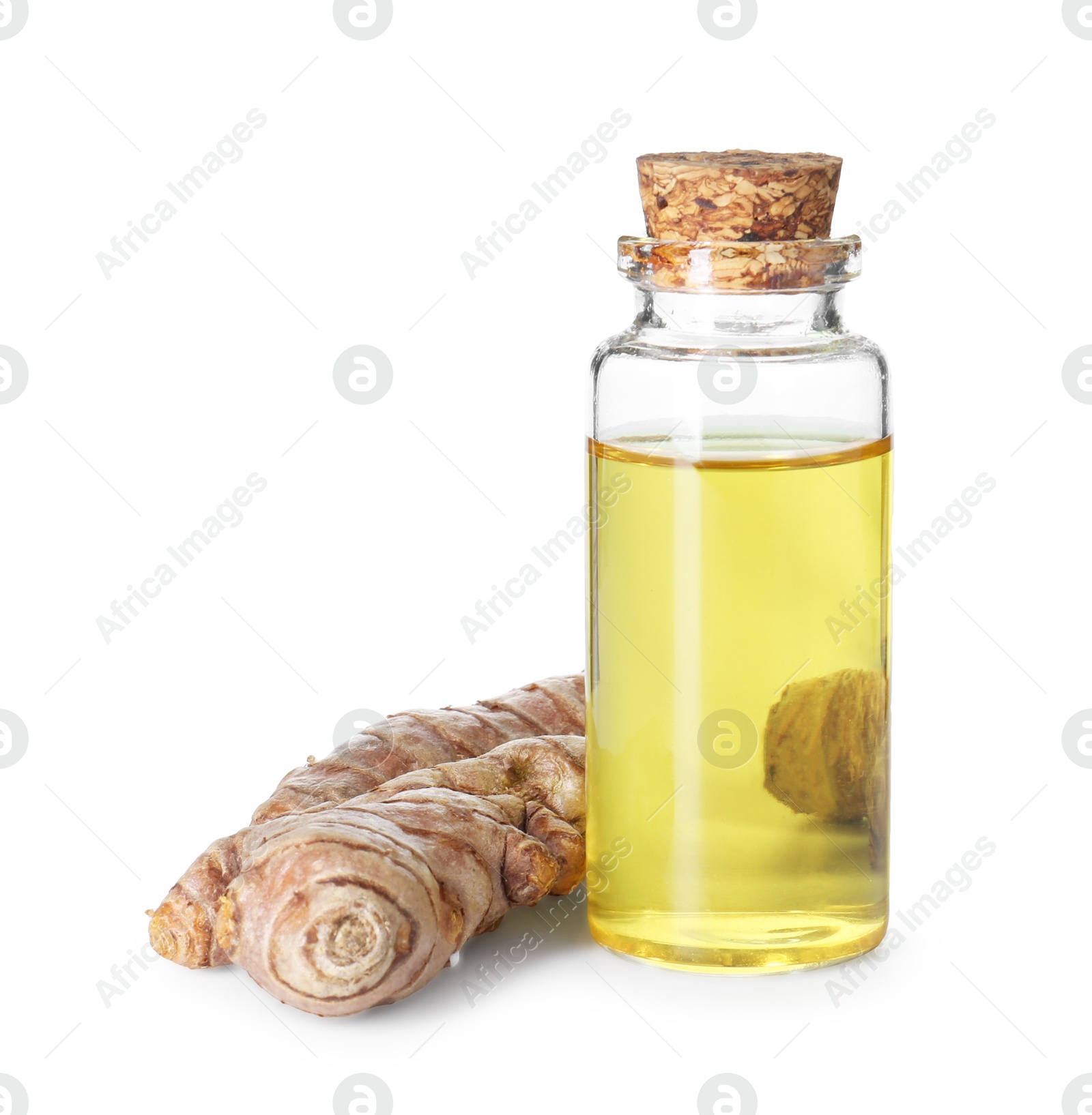 Photo of Bottle of turmeric essential oil and raw roots isolated on white