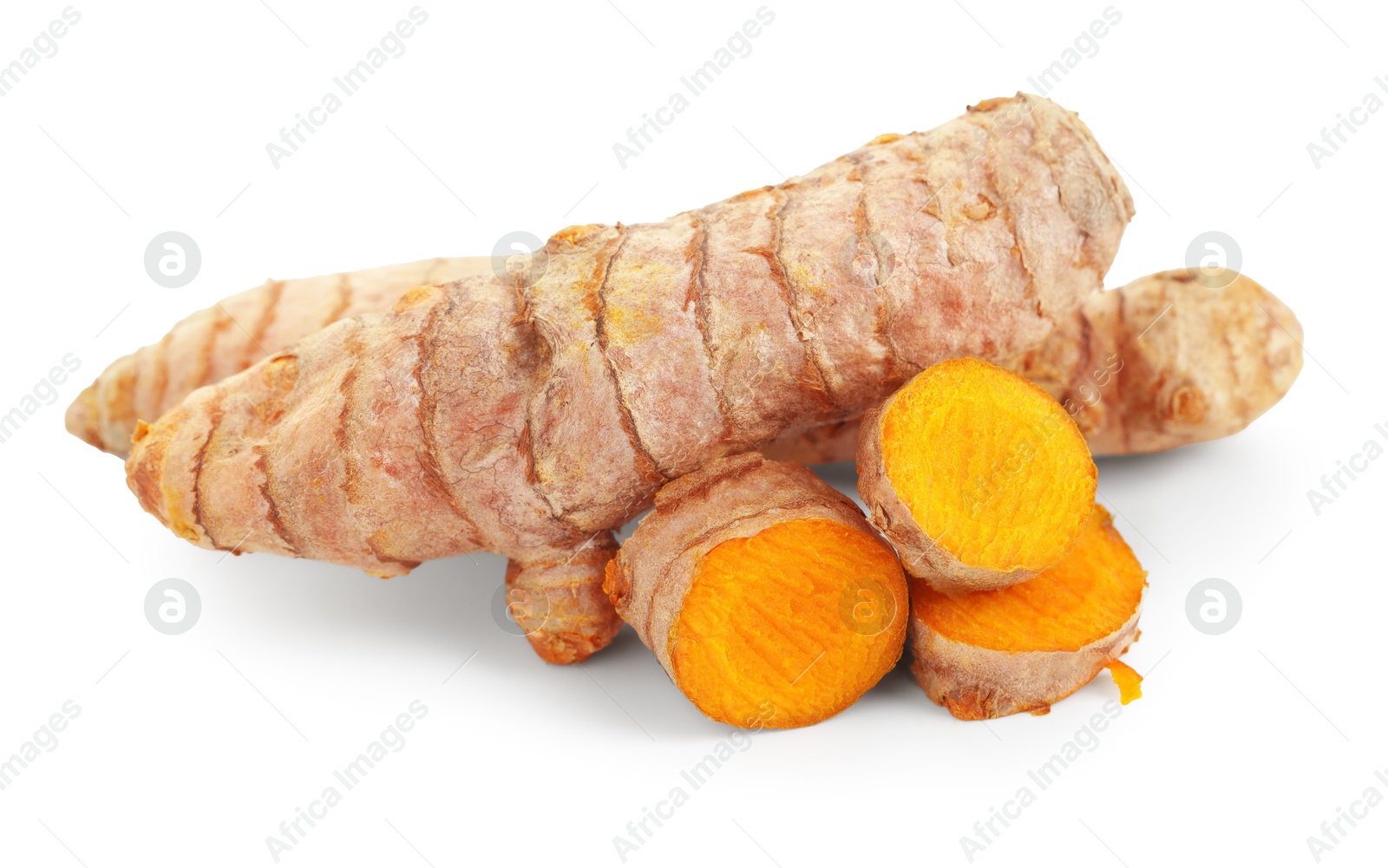 Photo of Pieces of tumeric rhizomes isolated on white