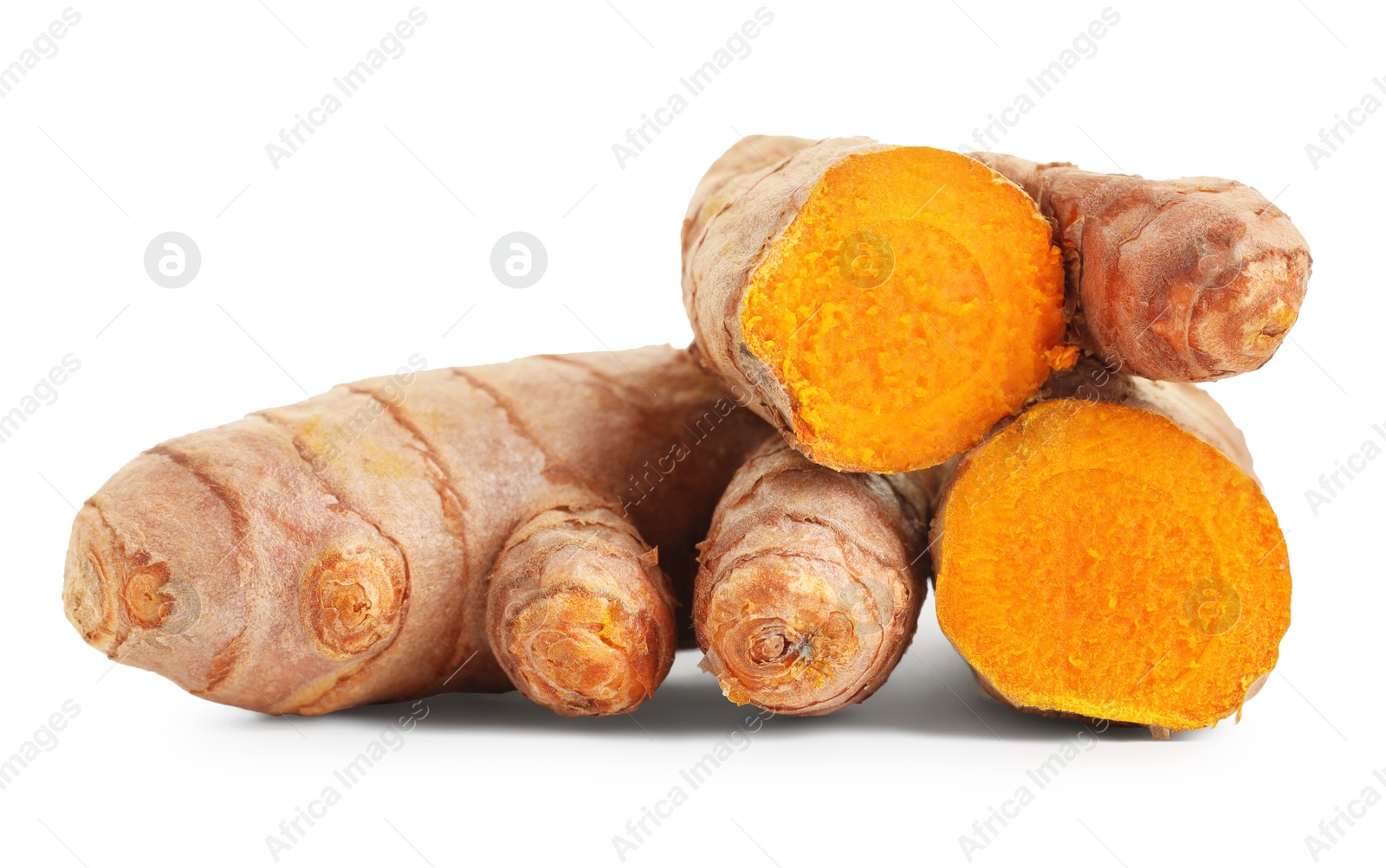 Photo of Pieces of tumeric rhizomes isolated on white