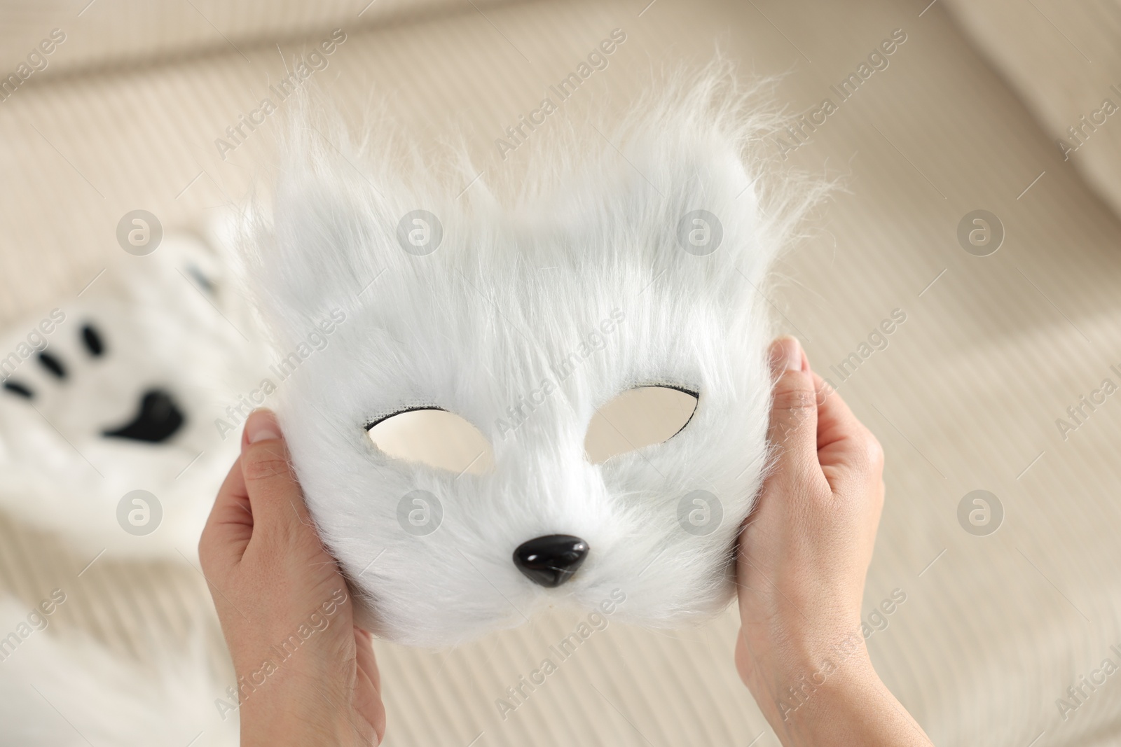 Photo of Quadrobics. Woman with furry cat mask on blurred background, closeup