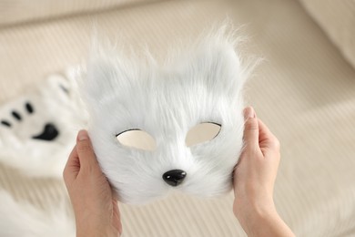 Photo of Quadrobics. Woman with furry cat mask on blurred background, closeup