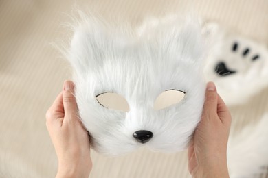 Photo of Quadrobics. Woman with furry cat mask on blurred background, closeup