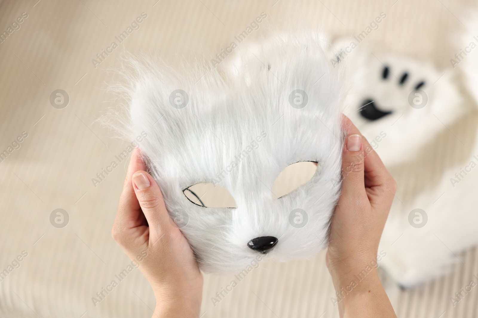 Photo of Quadrobics. Woman with furry cat mask on blurred background, closeup