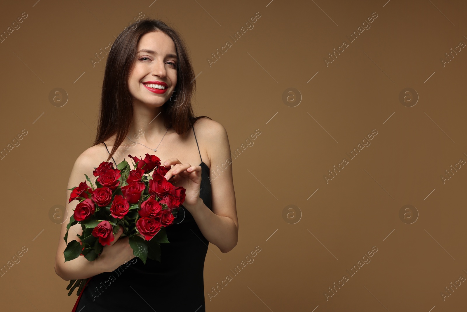 Photo of Happy Valentine's Day. Beautiful woman with bouquet of roses on brown background. Space for text