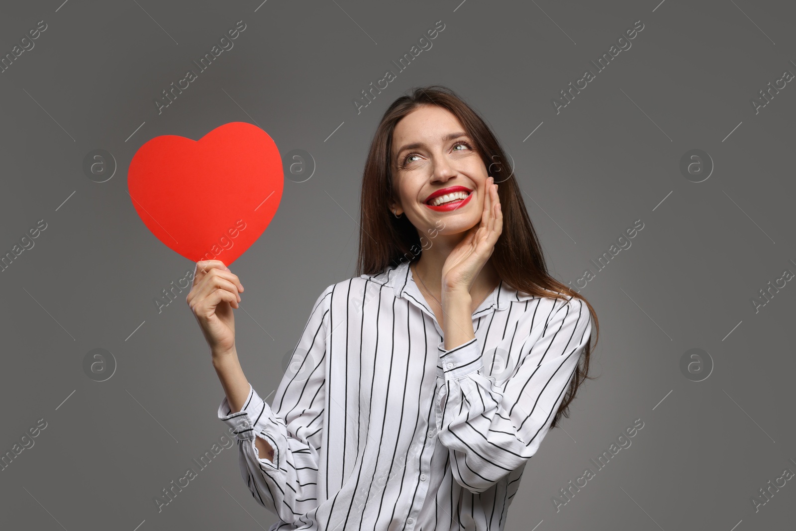 Photo of Happy Valentine's Day. Beautiful woman with paper heart on grey background