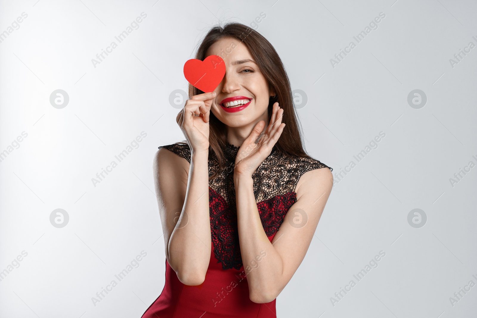 Photo of Happy Valentine's Day. Beautiful woman with paper heart on white background