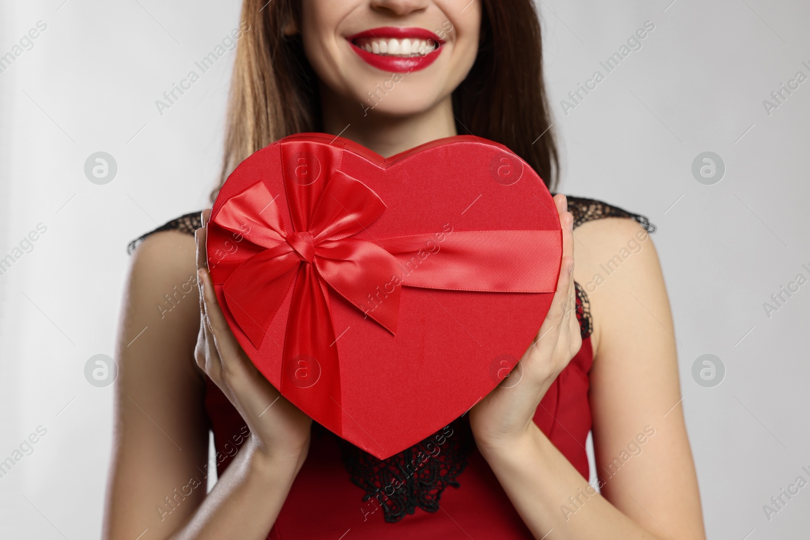 Photo of Happy Valentine's Day. Woman with heart shaped gift box on white background, closeup